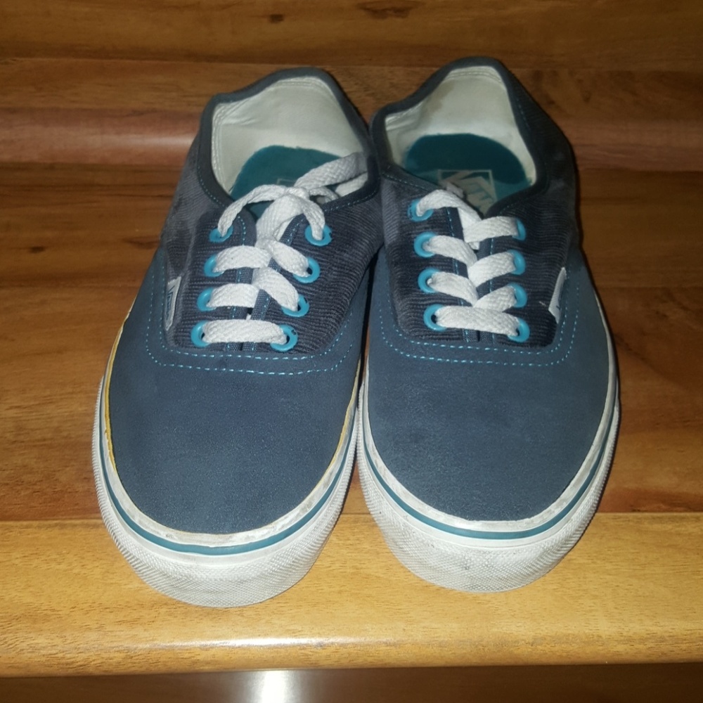 Blue vans with corduroy siding.
